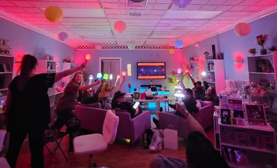 Concert watch party with lightsticks and fans